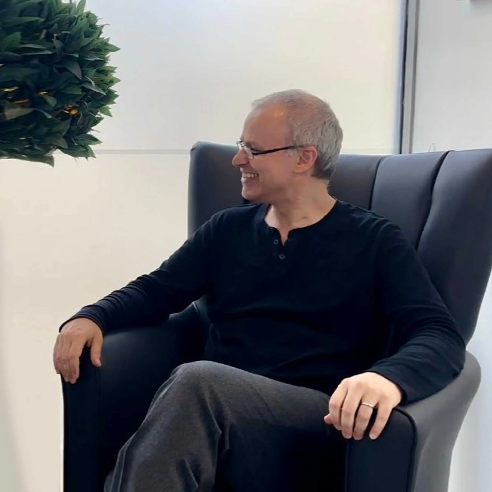 Dr Joannis Vamvakopoulos seated in an armchair